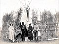 "A village of the Arapahoes (sic)." (Arapaho family group in front of a teepee in the Department of Anthropology at the 1904 World's Fair.jpg