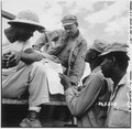 "... troops in Burma stop work briefly to read President Truman's Proclamation of Victory in Europe." - NARA - 531341.tif